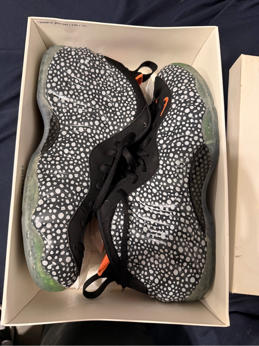 NIKE MEN Black/White Speckle Foamposite Sneakers with Orange Accents